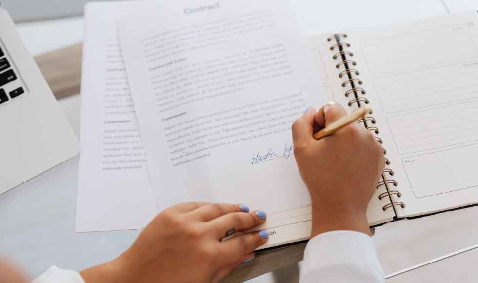 person signing a contract
